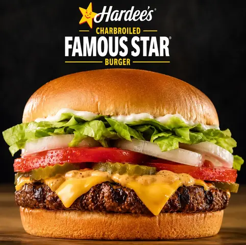 Hardee's Famous Star charbroiled burger with lettuce, tomato, and sauce on a sesame bun